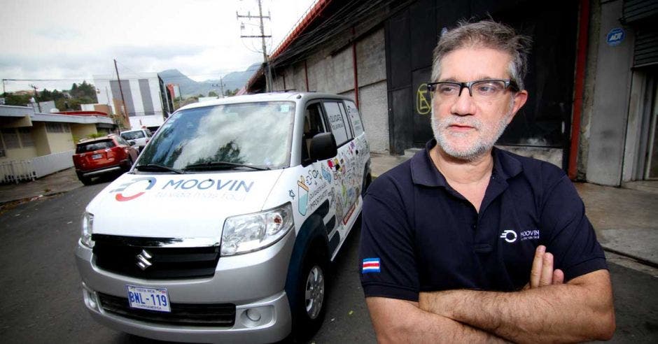 Javier Núñez, dueño de Moovin, posa junto a uno de los autos repartidores