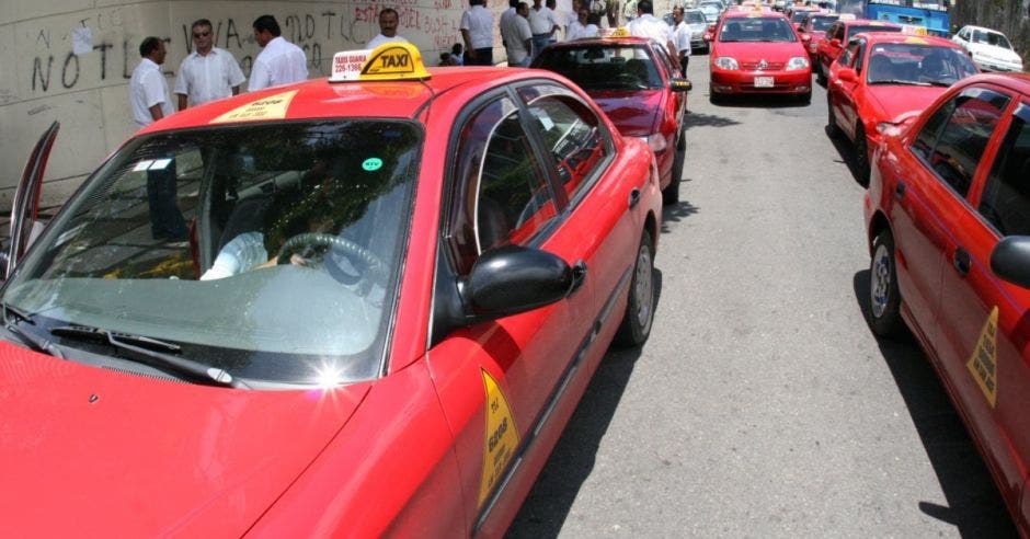 Una fila de vehículos taxis haciendo presa