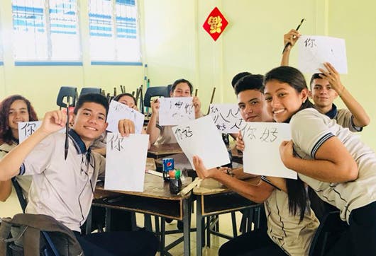 Estudiantes ticos practican escribir caracteres chinos en el colegio de parte del programa Hablemos en Mandarín.