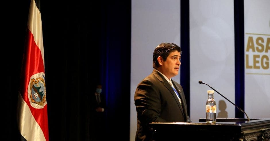 un hombre de contextura gruesa habla en un auditorio