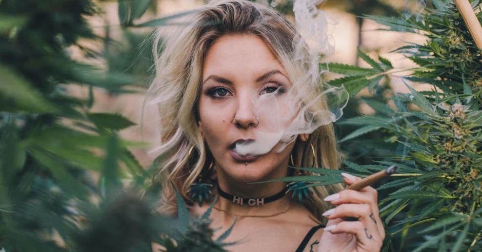 una mujer fumando un puro de marihuana