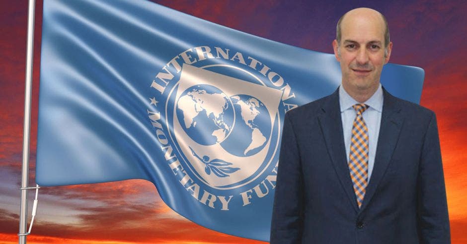 un hombre de traje y corbata sobre una bandera que dice International Monetary Fund