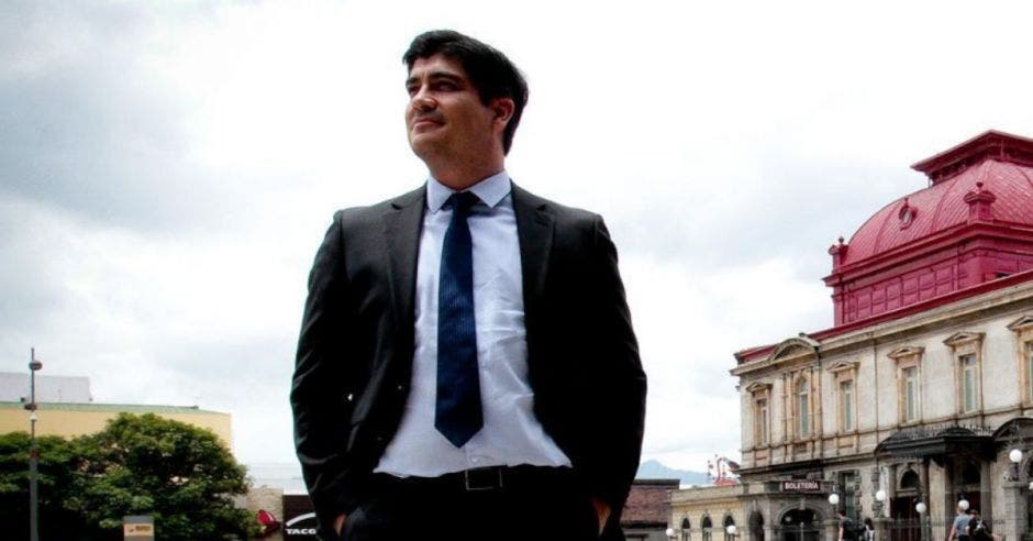 un hombre con saco azul, camisa blanca y pantalones azules