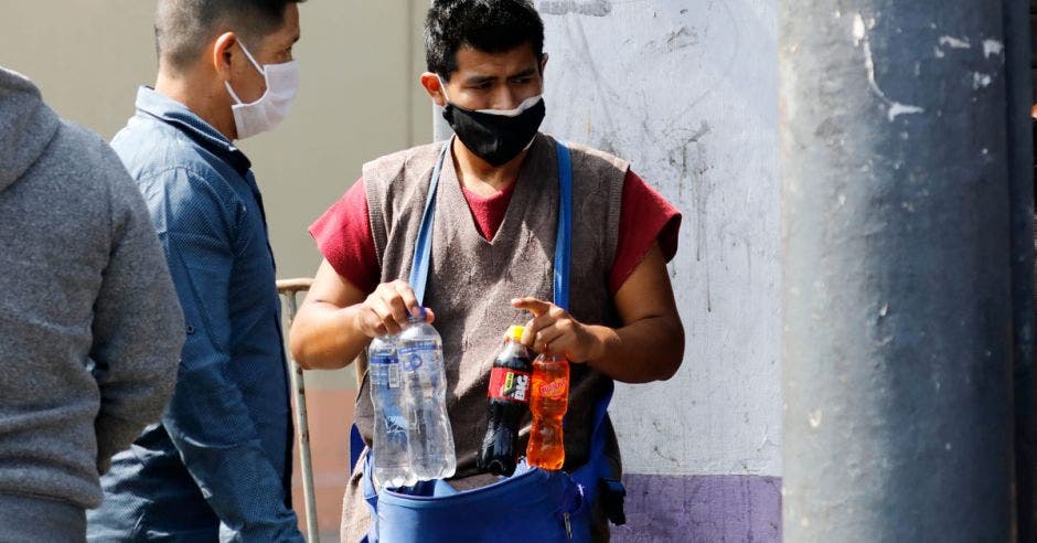 un hombre vende gaseosas en la vía pública