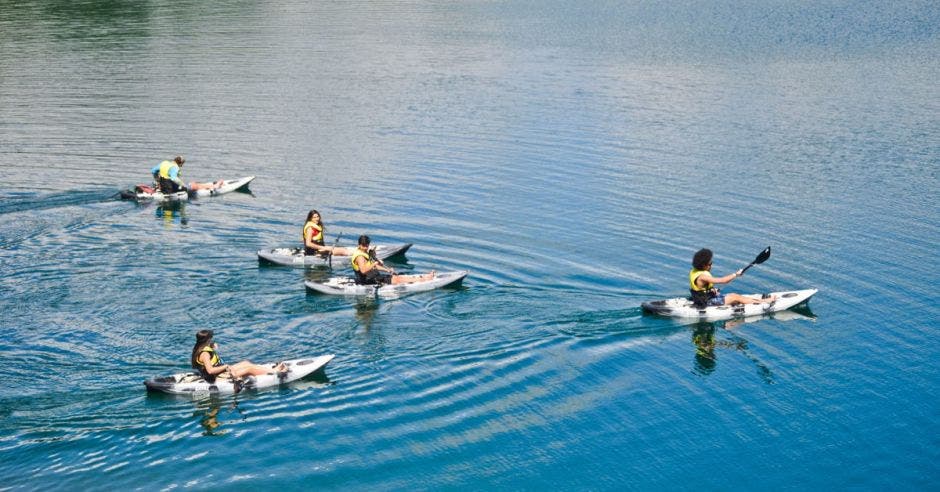 un grupo de personas recorre una laguna en kayak