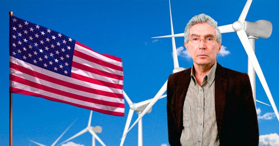 un hombre de camisa y saco sobre el fondo de la bandera de los estados unidos y varias torres eólicas