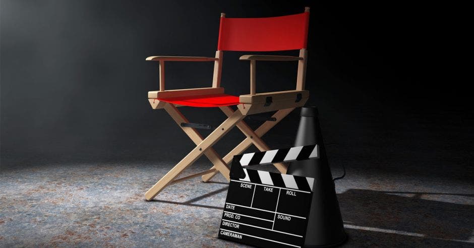 una silla de director de cine color rojo junto a una claqueta