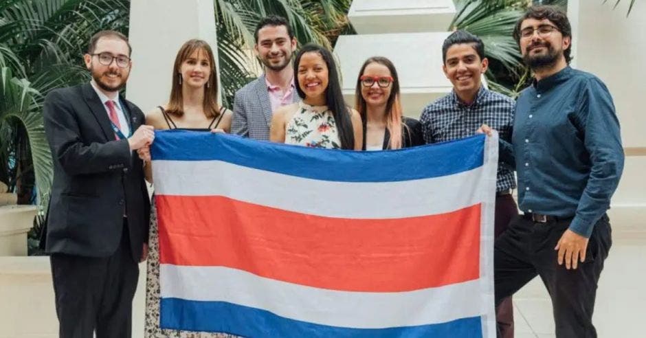 Siete costarricenses sosteniendo la bandera de Costa Rica