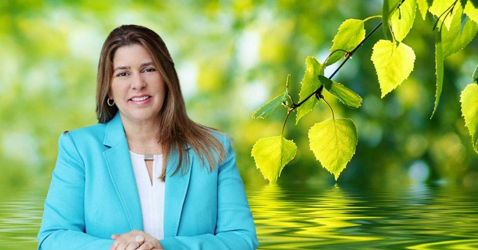 Mujer en saco celeste en un fondo de naturaleza verde