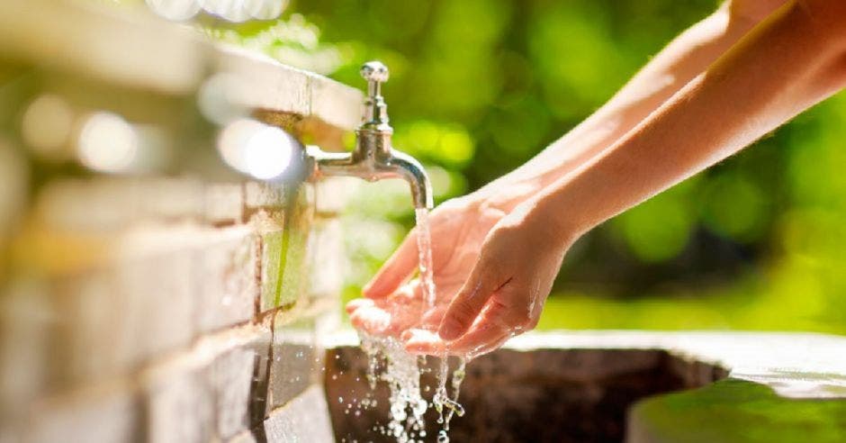 Persona abriendo un tubo de agua potable