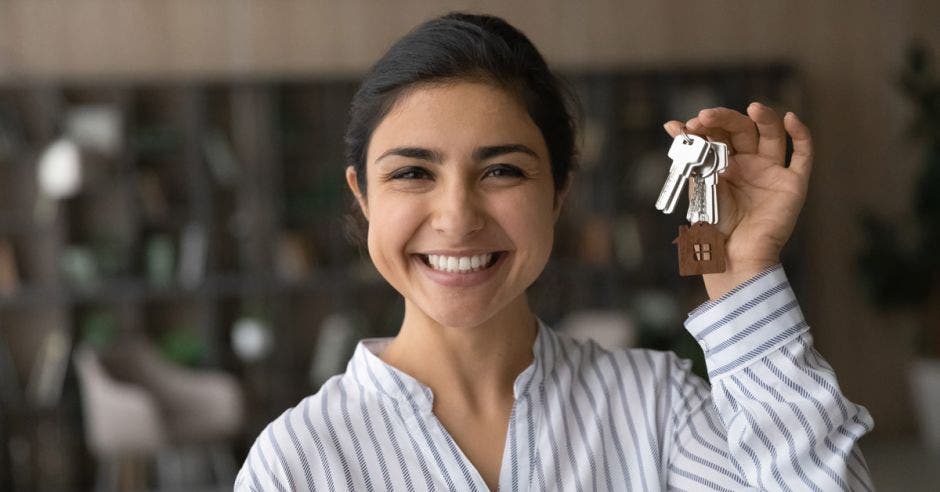 Mujer con un alleve de casa en la mano